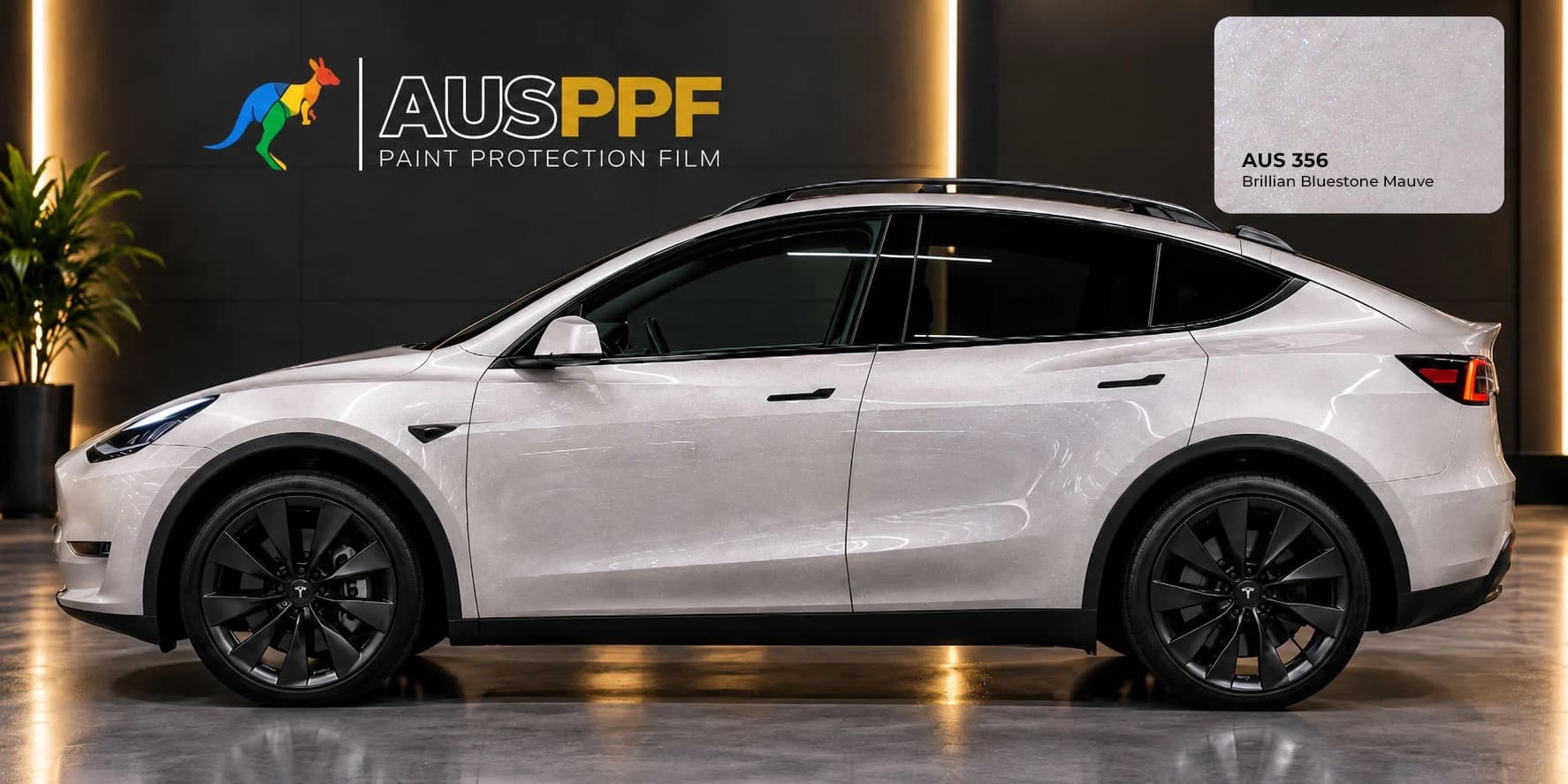 A vehicle wrapped in AusPPF Brilliant Bluestone Mauve paint protection film, photographed in a showroom.