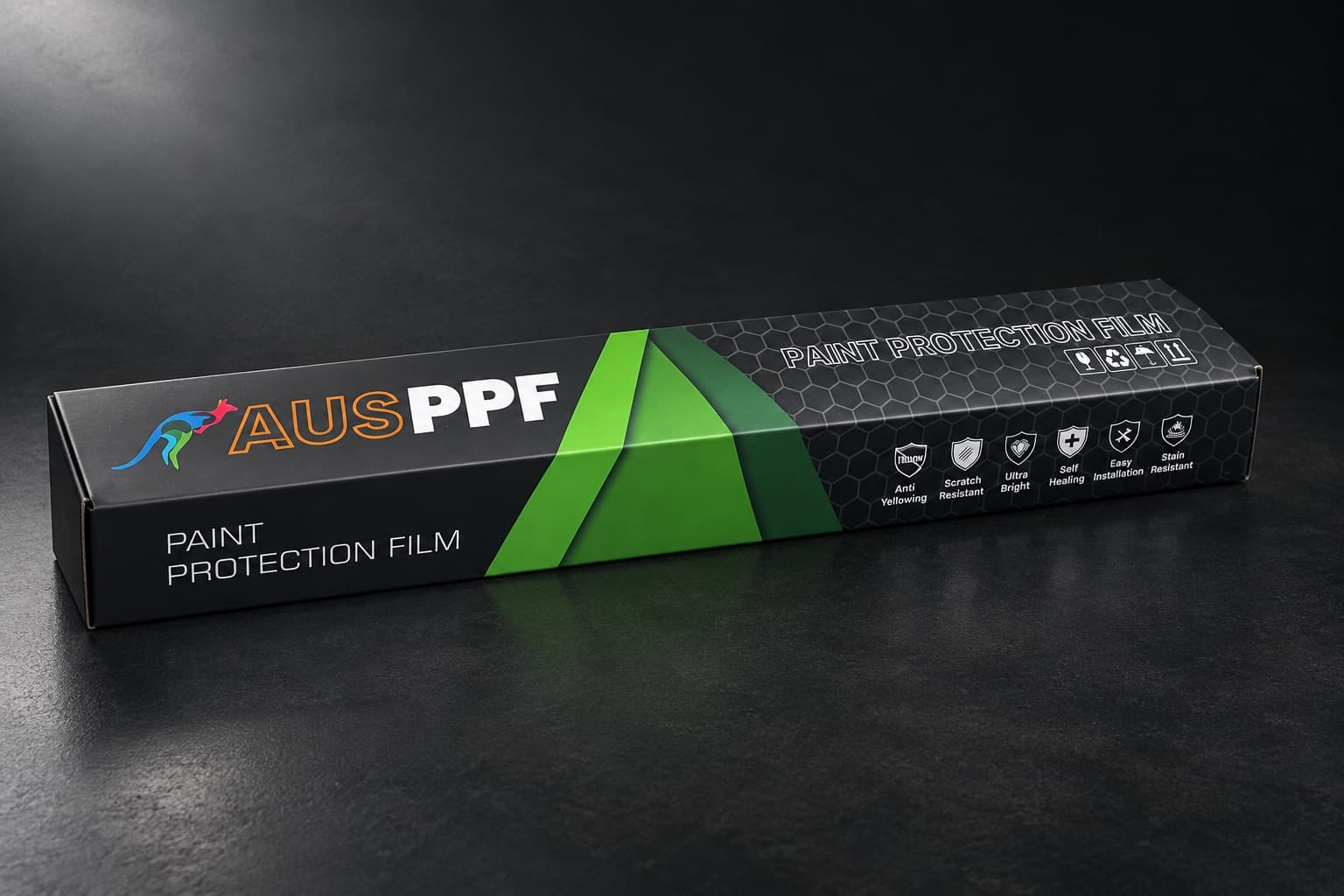 The AusPPF paint protection film box at an angle on a charcoal surface, with the AusPPF logo and green angled panels on the front.