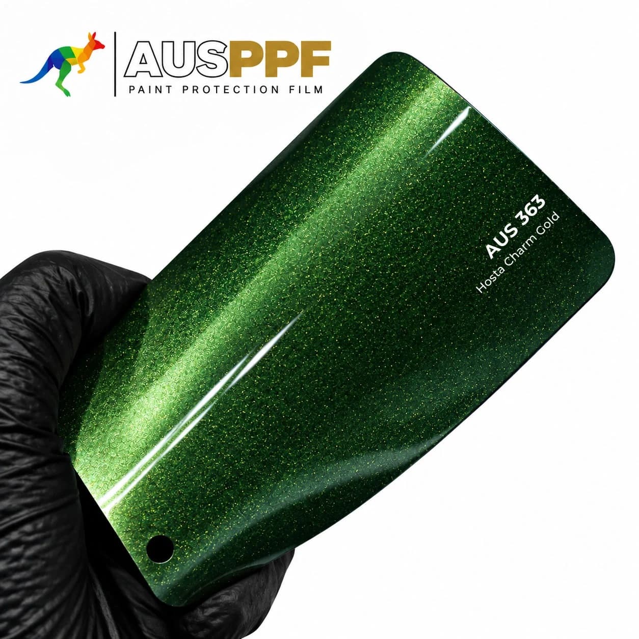 A gloved hand holding a swatch of AusPPF AUS-363 Hosta Charm Gold PPF, showing its gloss finish.