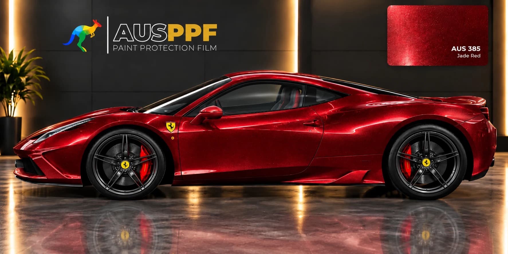 Another view of a vehicle wrapped in AusPPF Jade Red paint protection film, in a showroom.