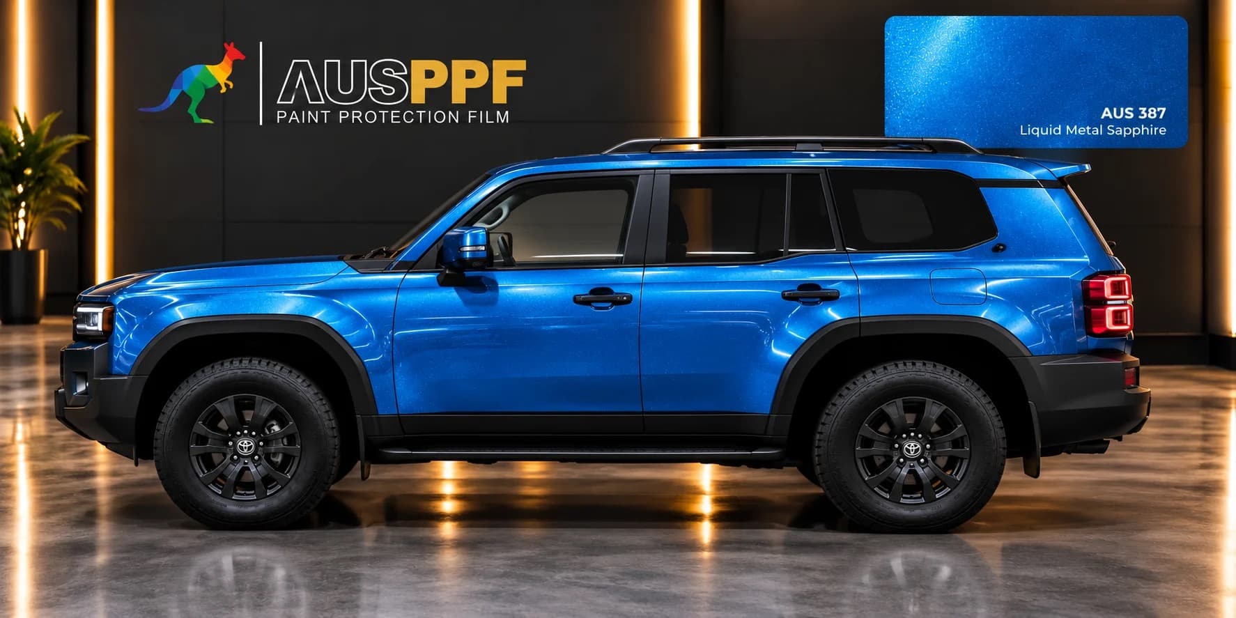 A vehicle wrapped in AusPPF Liquid Metal Sapphire paint protection film, photographed in a showroom.